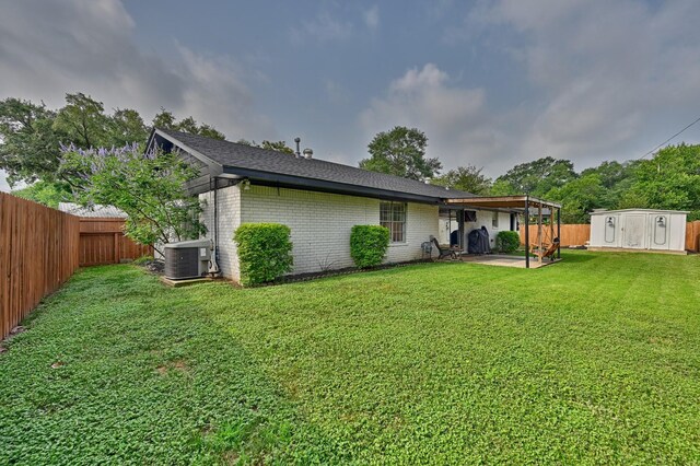 507 Sandra Dr, Brenham, TX 77833 - rear view of house with a patio, brick siding, cooling unit, and a shingled roof