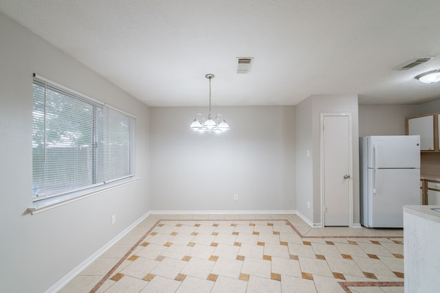 19914 Big Timber Dr, Humble, TX 77346 - unfurnished dining area with light tile patterned floors and a chandelier