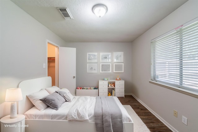 19914 Big Timber Dr, Humble, TX 77346 - bedroom featuring dark wood-style floors and baseboards