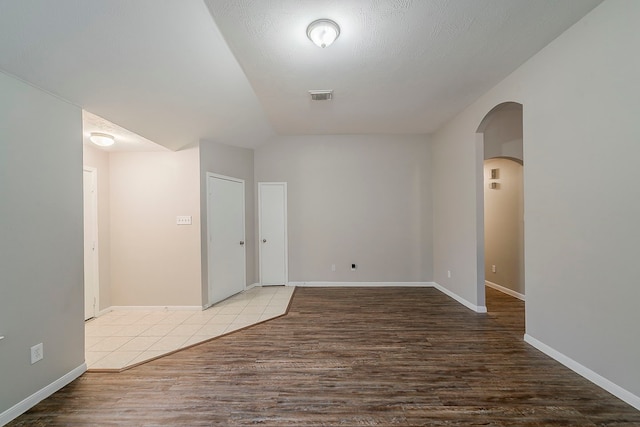 2511 Muscory Dr, Humble, TX 77396 - unfurnished room with arched walkways, wood finished floors, and baseboards