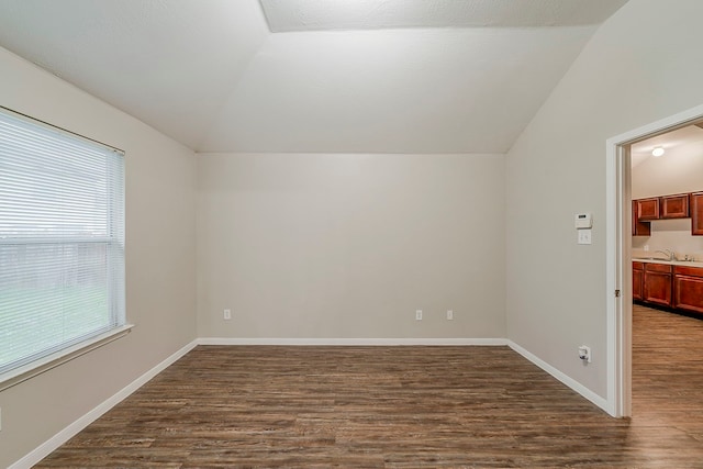 2511 Muscory Dr, Humble, TX 77396 - additional living space with vaulted ceiling, dark wood-type flooring, a sink, and baseboards