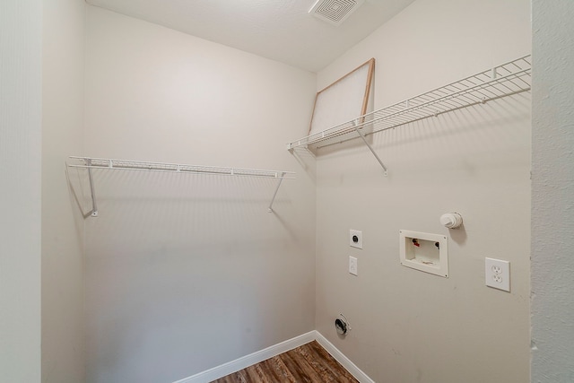 2511 Muscory Dr, Humble, TX 77396 - laundry area with hookup for an electric dryer, hookup for a washing machine, dark wood-type flooring, and baseboards