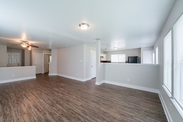 447 Vane Way, Crosby, TX 77532 - unfurnished living room with dark wood-type flooring, baseboards, and ceiling fan