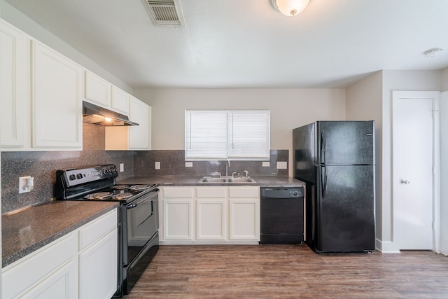 447 Vane Way, Crosby, TX 77532 - kitchen with black appliances, under cabinet range hood, a sink, decorative backsplash, and white cabinets