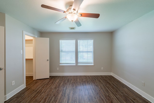 447 Vane Way, Crosby, TX 77532 - unfurnished room featuring dark wood-style flooring, a ceiling fan, and baseboards
