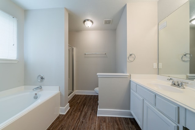 447 Vane Way, Crosby, TX 77532 - bathroom with wood finished floors, vanity, toilet, a bath, and baseboards