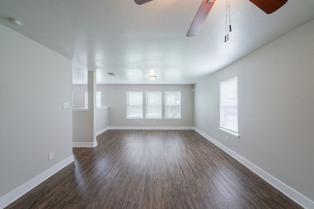 447 Vane Way, Crosby, TX 77532 - unfurnished room featuring ceiling fan, healthy amount of natural light, dark wood finished floors, baseboards, and a textured ceiling
