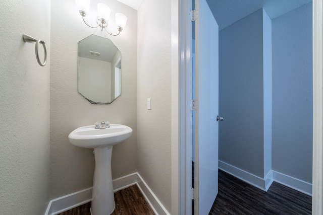 447 Vane Way, Crosby, TX 77532 - bathroom featuring wood finished floors, baseboards, and a sink