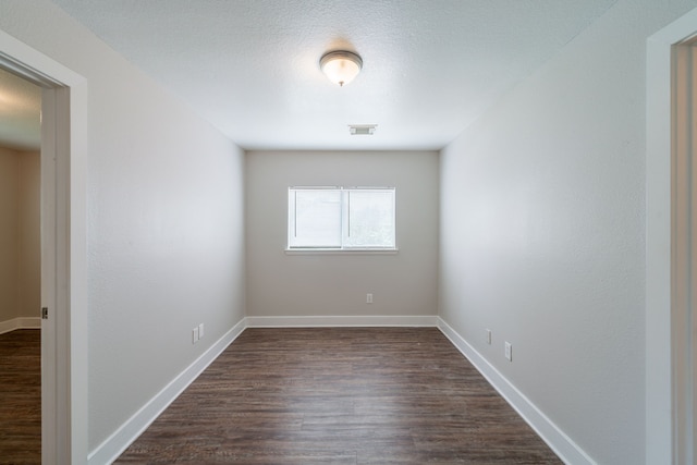 447 Vane Way, Crosby, TX 77532 - spare room featuring dark wood-style floors and baseboards