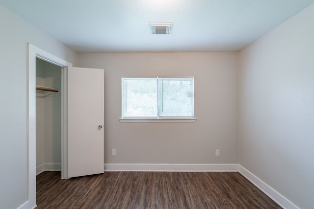 447 Vane Way, Crosby, TX 77532 - unfurnished bedroom featuring dark wood-style flooring, baseboards, and a closet