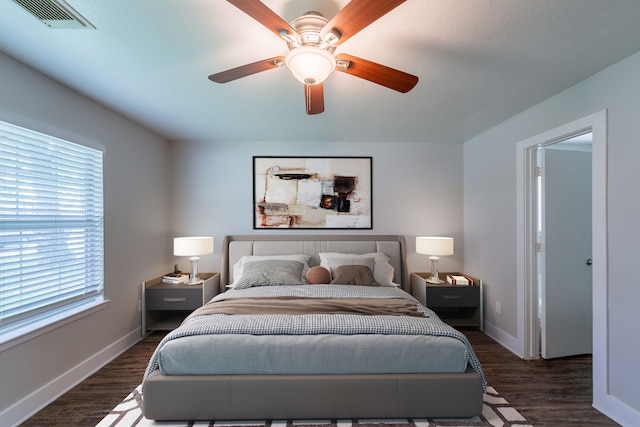 447 Vane Way, Crosby, TX 77532 - bedroom featuring multiple windows, dark wood-style floors, and baseboards