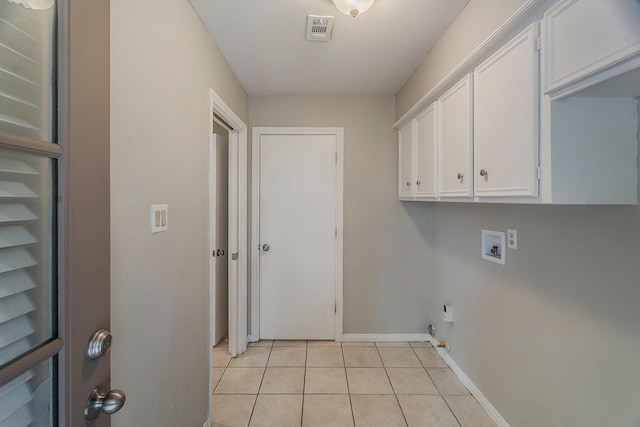 5206 Graystone Ln, Houston, TX 77069 - laundry room featuring washer hookup, light tile patterned floors, cabinet space, baseboards, and hookup for an electric dryer