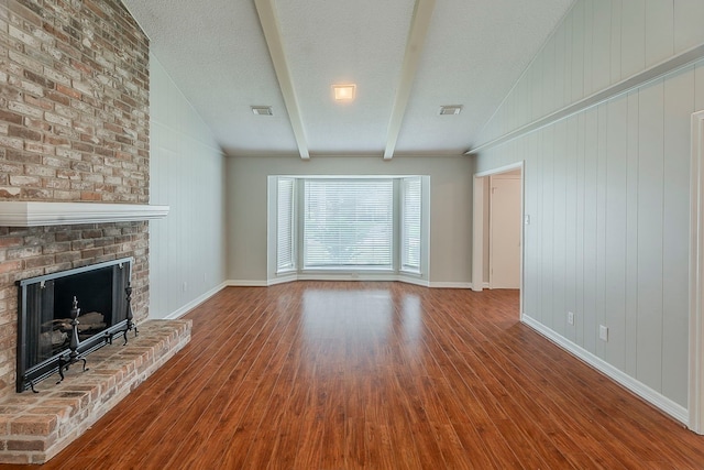 5206 Graystone Ln, Houston, TX 77069 - unfurnished living room featuring wood finished floors, a fireplace, baseboards, and wooden walls