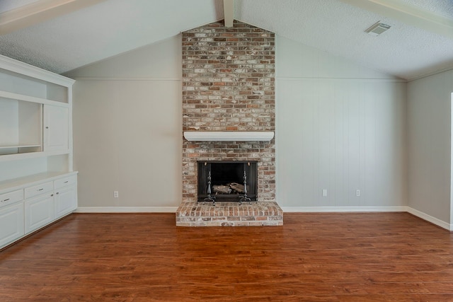 5206 Graystone Ln, Houston, TX 77069 - unfurnished living room featuring wood finished floors, vaulted ceiling, a brick fireplace, and a textured ceiling