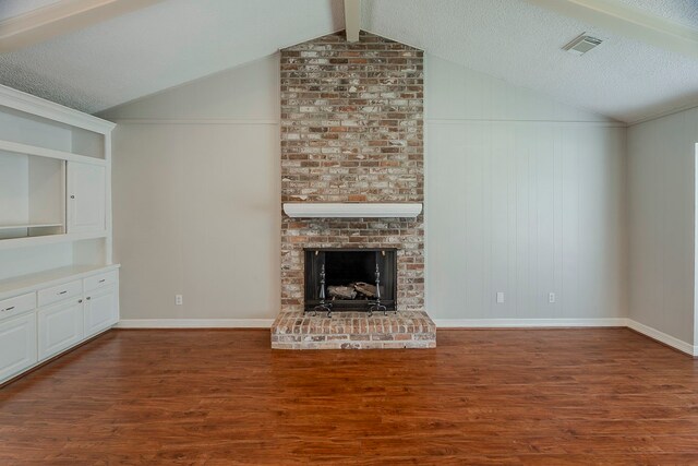 5206 Graystone Ln, Houston, TX 77069 - unfurnished living room with wood finished floors, vaulted ceiling, a fireplace, and a textured ceiling
