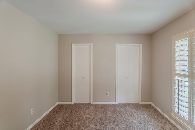5206 Graystone Ln, Houston, TX 77069 - unfurnished bedroom featuring two closets, carpet floors, and baseboards