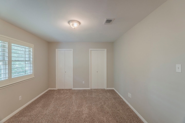 5206 Graystone Ln, Houston, TX 77069 - unfurnished bedroom featuring carpet flooring, baseboards, and multiple closets