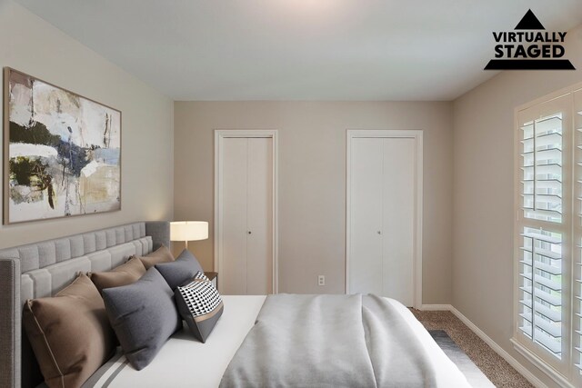 5206 Graystone Ln, Houston, TX 77069 - bedroom featuring two closets, carpet floors, and baseboards