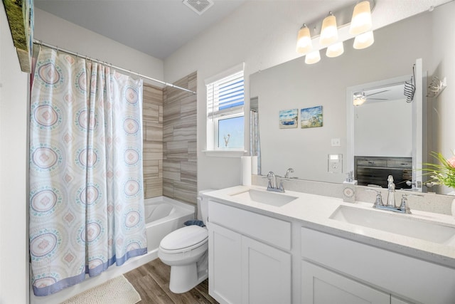 6846 Termino Ln, Rosharon, TX 77583 - bathroom with double vanity, shower / bathtub combination with curtain, wood finished floors, toilet, and ceiling fan