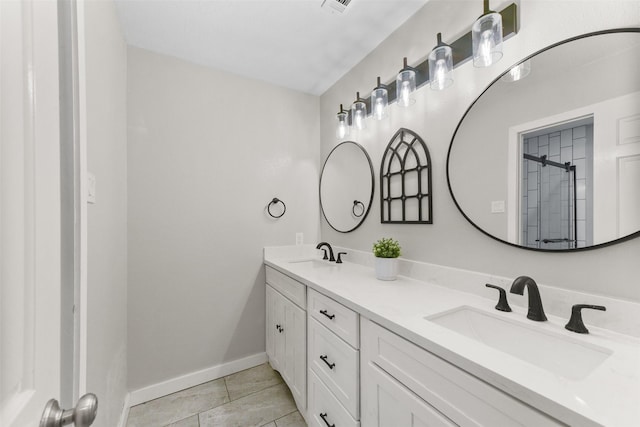 704 Balmoral Ct, Friendswood, TX 77546 - bathroom with double vanity, tile patterned floors, baseboards, and a shower with shower door