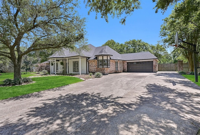 704 Balmoral Ct, Friendswood, TX 77546 - view of front of home with brick siding, a garage, driveway, and a shingled roof