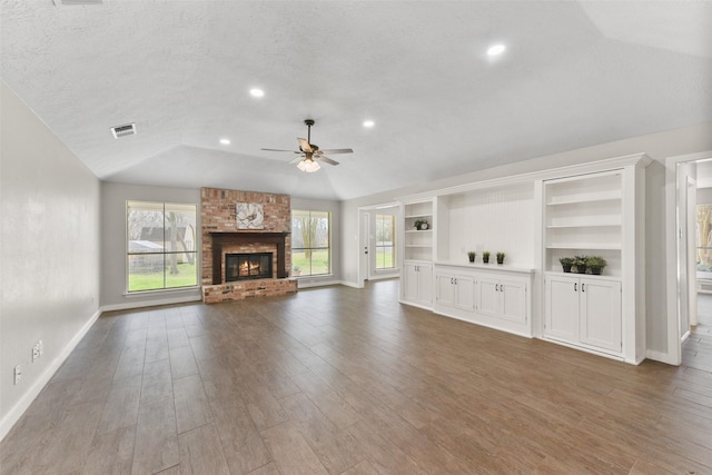 704 Balmoral Ct, Friendswood, TX 77546 - unfurnished living room with vaulted ceiling, ceiling fan, healthy amount of natural light, wood finished floors, and recessed lighting