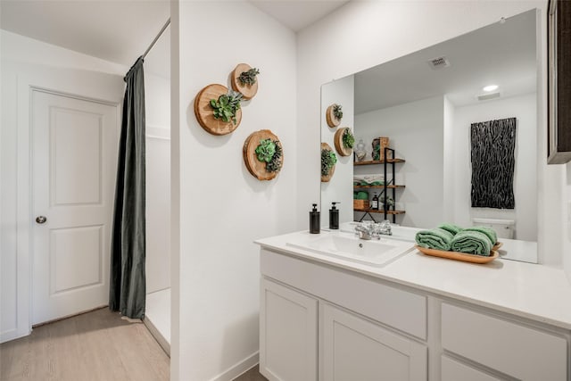 277 Douglas Hills Dr, Magnolia, TX 77354 - bathroom with a shower with curtain, wood finished floors, vanity, and baseboards