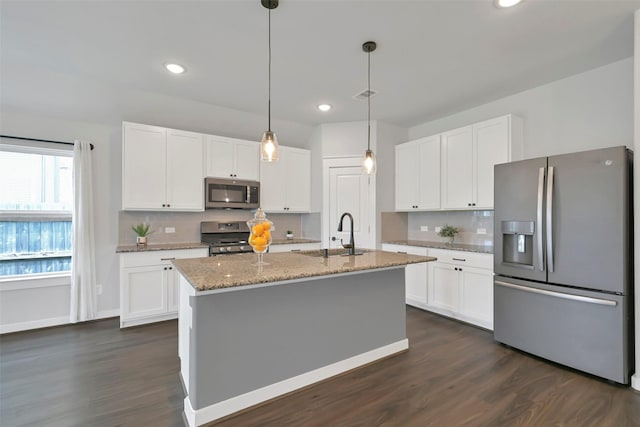 12307 Sabine Point Dr, Humble, TX 77346 - kitchen with appliances with stainless steel finishes, a sink, tasteful backsplash, white cabinetry, and light stone counters