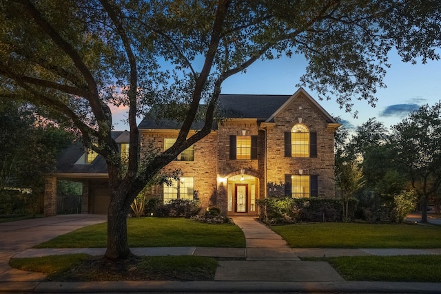 11802 Rue Saint Honore Ct, Tomball, TX 77377 - colonial inspired home with a front lawn, driveway, brick siding, and an attached garage