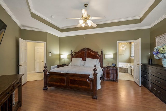 11802 Rue Saint Honore Ct, Tomball, TX 77377 - bedroom featuring a tray ceiling, wood finished floors, crown molding, and ceiling fan