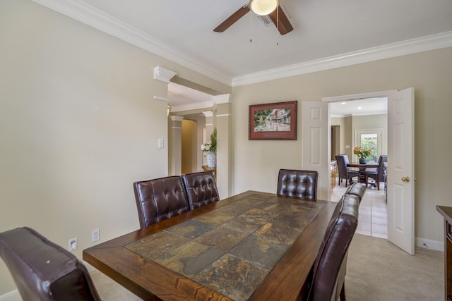 11802 Rue Saint Honore Ct, Tomball, TX 77377 - dining space featuring crown molding, a ceiling fan, ornate columns, baseboards, and light carpet