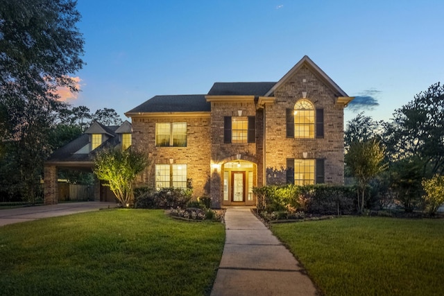 11802 Rue Saint Honore Ct, Tomball, TX 77377 - georgian-style home with a front yard and brick siding