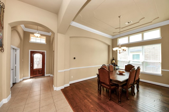 22714 Wilbur Ln, Tomball, TX 77375 - dining space with a chandelier, arched walkways, healthy amount of natural light, baseboards, and crown molding