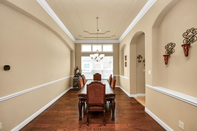 22714 Wilbur Ln, Tomball, TX 77375 - dining area featuring a chandelier, ornamental molding, dark wood-style flooring, arched walkways, and baseboards