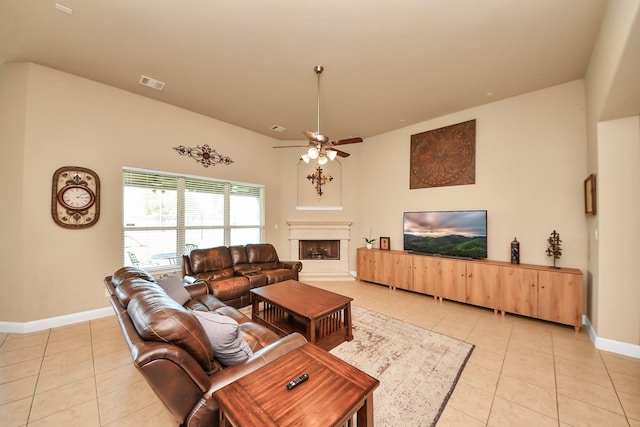 22714 Wilbur Ln, Tomball, TX 77375 - living room with light tile patterned floors, a fireplace with raised hearth, baseboards, and ceiling fan