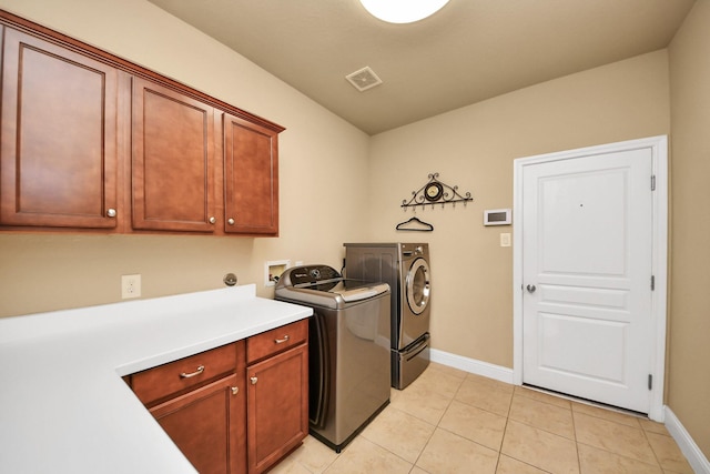 22714 Wilbur Ln, Tomball, TX 77375 - washroom featuring cabinet space, baseboards, separate washer and dryer, and light tile patterned flooring