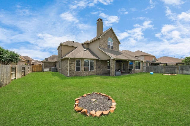 22714 Wilbur Ln, Tomball, TX 77375 - rear view of house with a chimney, central AC, roof with shingles, a patio area, and a trampoline