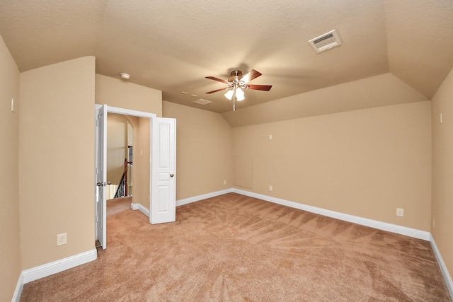 22714 Wilbur Ln, Tomball, TX 77375 - unfurnished bedroom with lofted ceiling, light carpet, baseboards, a ceiling fan, and a textured ceiling