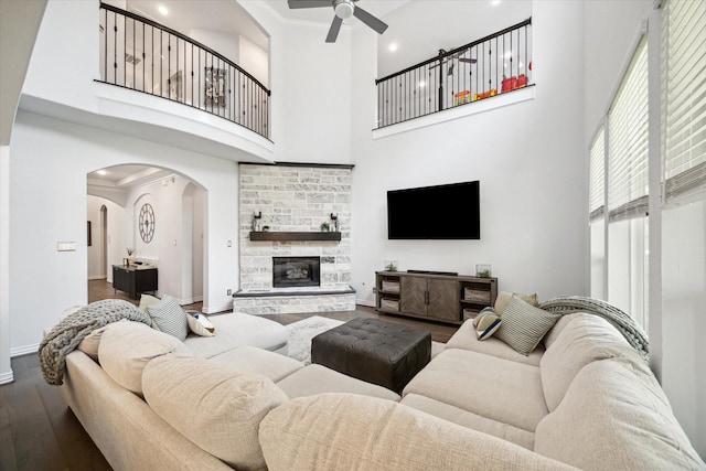 1120 Wakefield Dr, Houston, TX 77018 - living area with ceiling fan, dark wood-style floors, a high ceiling, arched walkways, and a fireplace