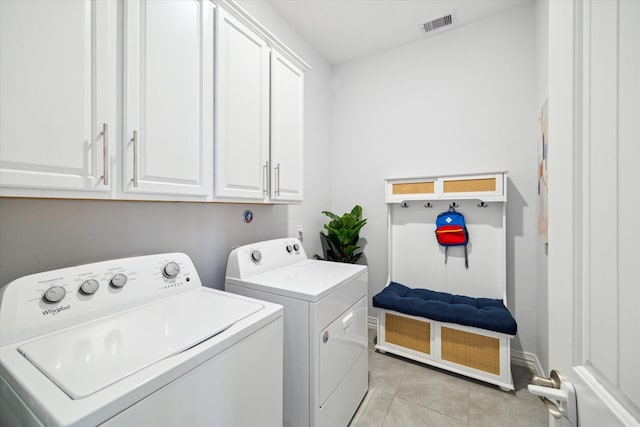 1120 Wakefield Dr, Houston, TX 77018 - washroom with washing machine and clothes dryer, cabinet space, light tile patterned floors, and baseboards