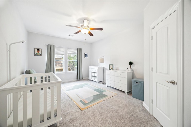 1120 Wakefield Dr, Houston, TX 77018 - bedroom featuring a nursery area, light carpet, and ceiling fan