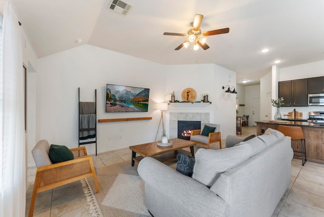 9998 Chimney Swift Ln, Conroe, TX 77385 - living area featuring ceiling fan, light tile patterned flooring, a tiled fireplace, lofted ceiling, and recessed lighting