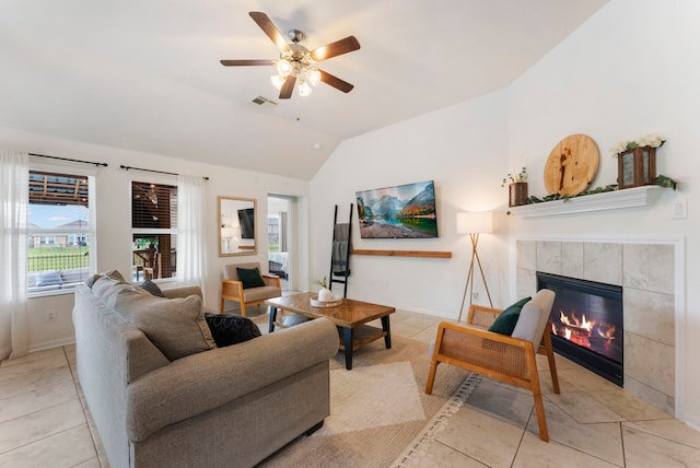 9998 Chimney Swift Ln, Conroe, TX 77385 - living room with a fireplace, lofted ceiling, light tile patterned floors, ceiling fan, and baseboards