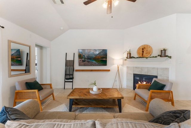 9998 Chimney Swift Ln, Conroe, TX 77385 - living room featuring ceiling fan, vaulted ceiling, tile patterned floors, a tile fireplace, and baseboards