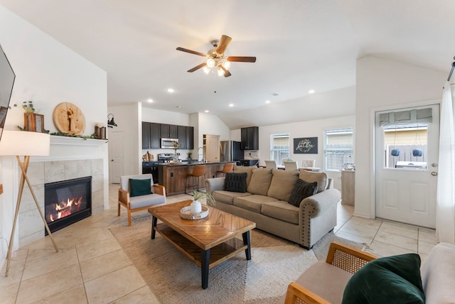 9998 Chimney Swift Ln, Conroe, TX 77385 - living area featuring lofted ceiling, a ceiling fan, a tile fireplace, recessed lighting, and light tile patterned floors