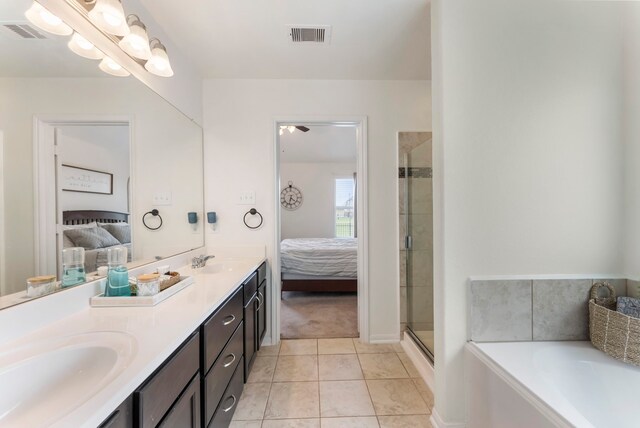 9998 Chimney Swift Ln, Conroe, TX 77385 - full bathroom featuring ensuite bath, double vanity, a garden tub, and a shower stall
