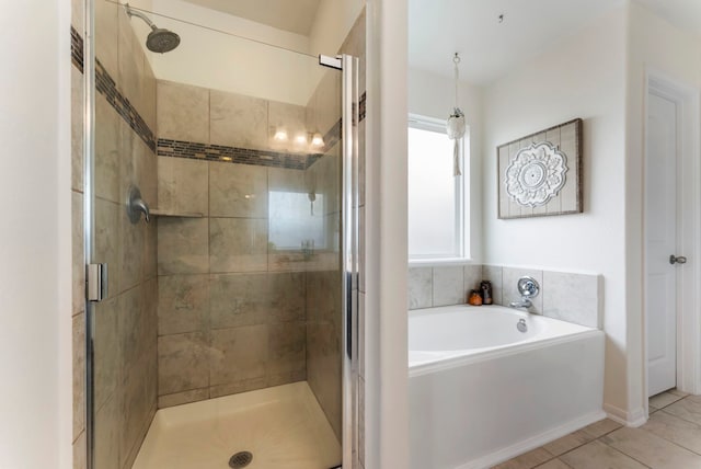 9998 Chimney Swift Ln, Conroe, TX 77385 - bathroom featuring a bath, a shower stall, and tile patterned flooring