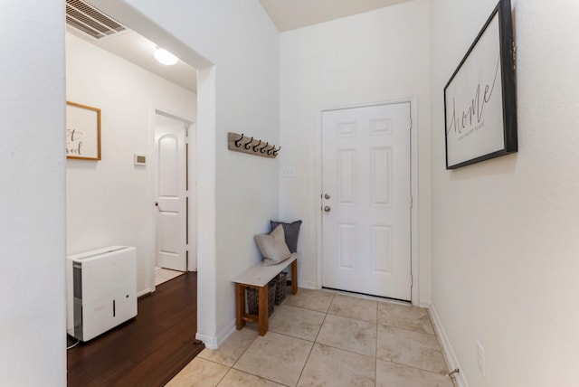9998 Chimney Swift Ln, Conroe, TX 77385 - doorway to outside featuring baseboards and light tile patterned floors