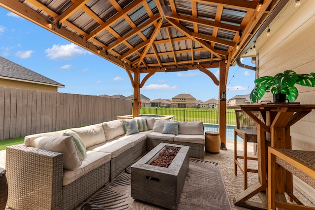 9998 Chimney Swift Ln, Conroe, TX 77385 - fenced backyard featuring an outdoor living space with a fire pit, a gazebo, a patio area, and a residential view