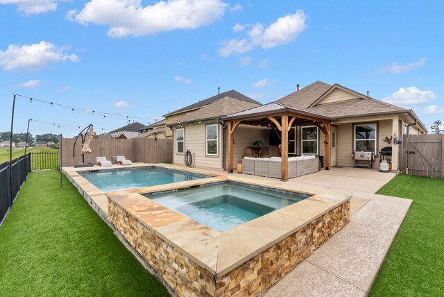 9998 Chimney Swift Ln, Conroe, TX 77385 - view of pool with an in-ground hot tub, a gate, a patio, and an outdoor hangout area